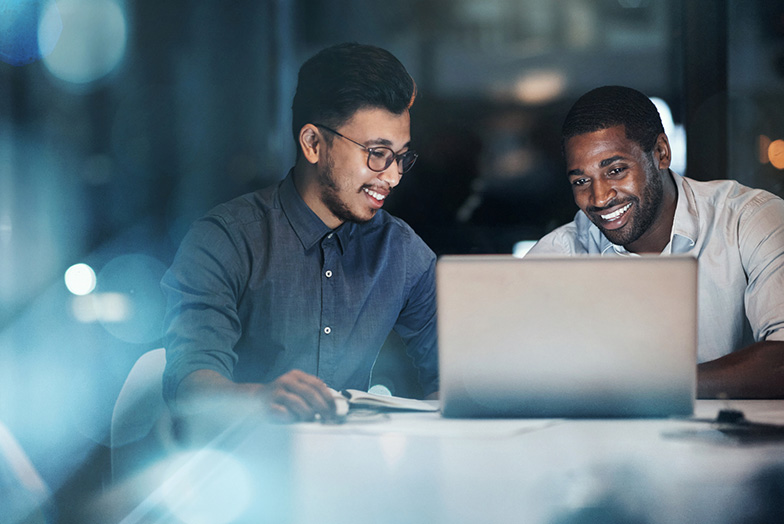 Two people looking at a laptop