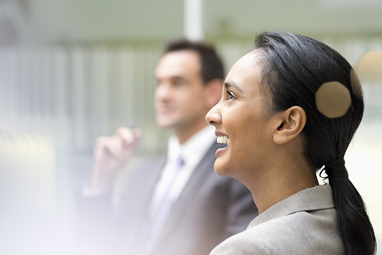 Persons in office smiling