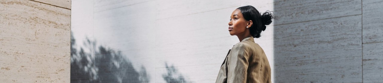 confident young person walking down light-stone coloured walkway