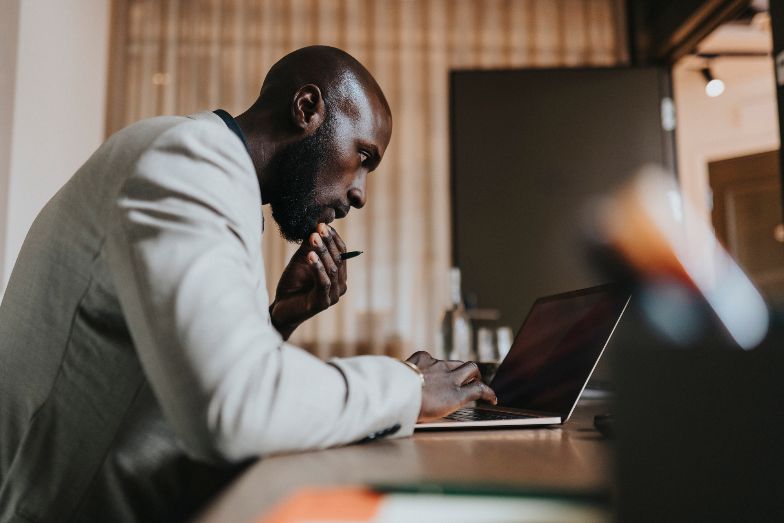 focused person typing on a laptop
