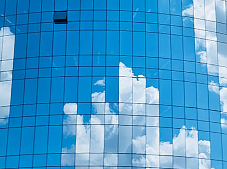 Clouds reflected on glass prism structure