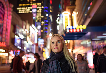 person in busy city at night