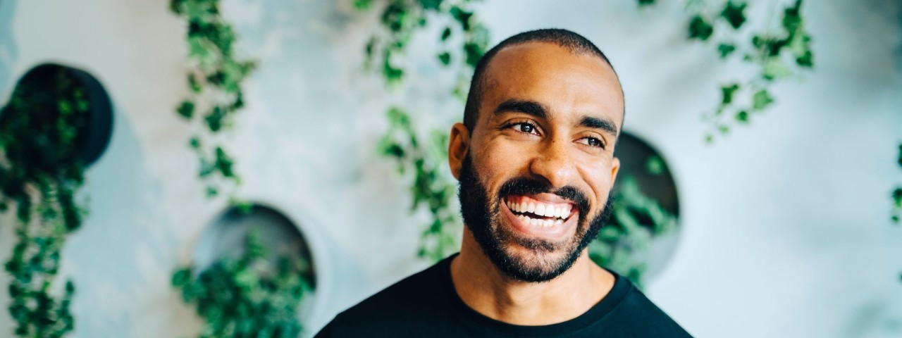 smiling man with shaved head