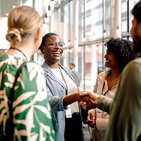 woman at event shaking hands with a man