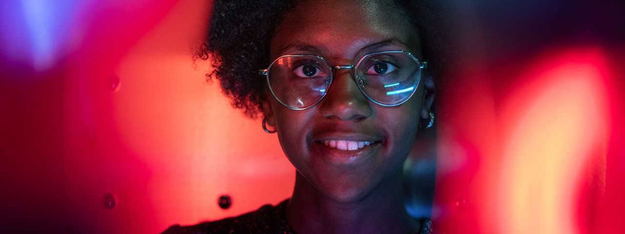 Person smiling in front of vivid background colours