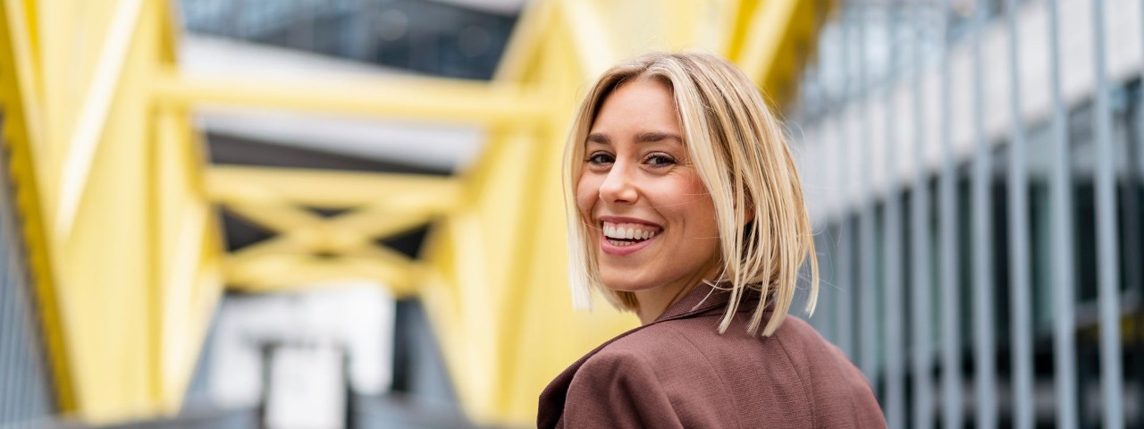 young person walking over a bridge