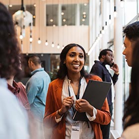 woman chatting with others at an event