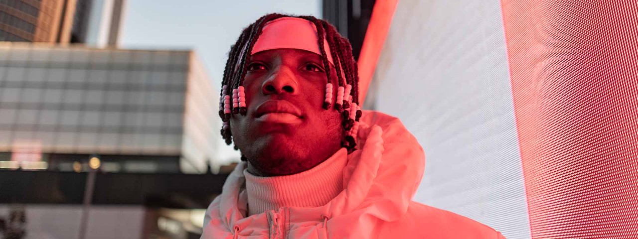 Person looking skywards in urban setting 