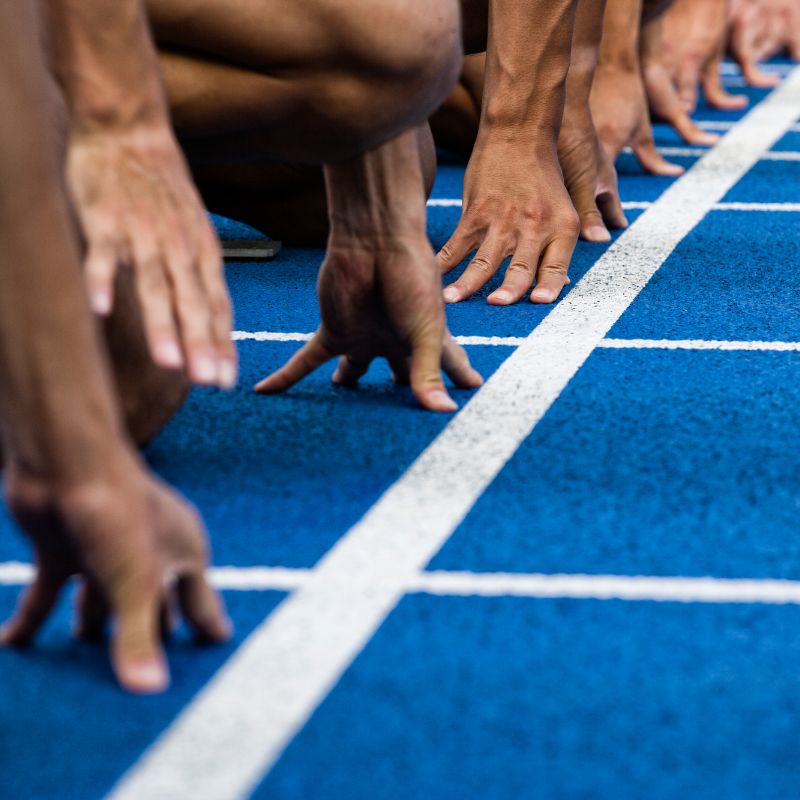Runners kneeling at race starting line