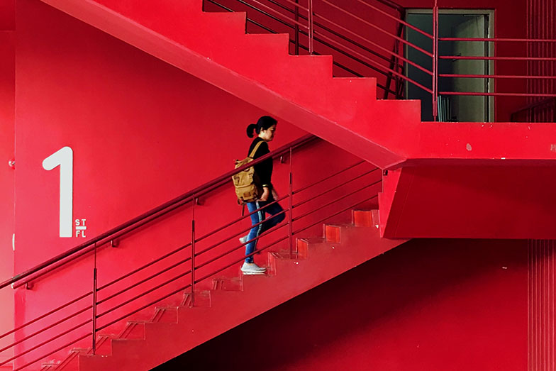 person climbing red stairs