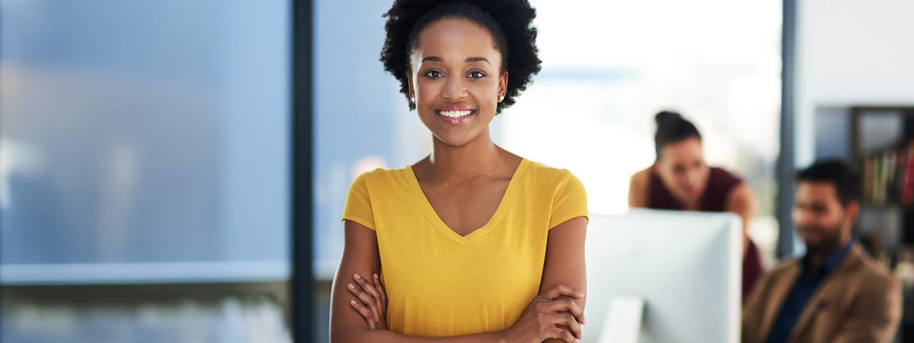 Person smiling with bike in urban setting