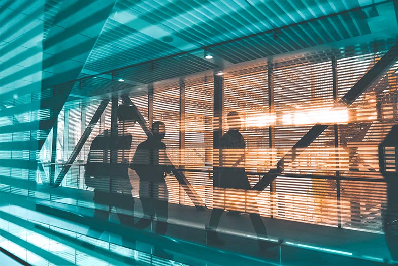 silhouette of people seen through window