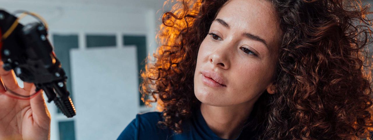Person looking inquisitive while handling handheld technology